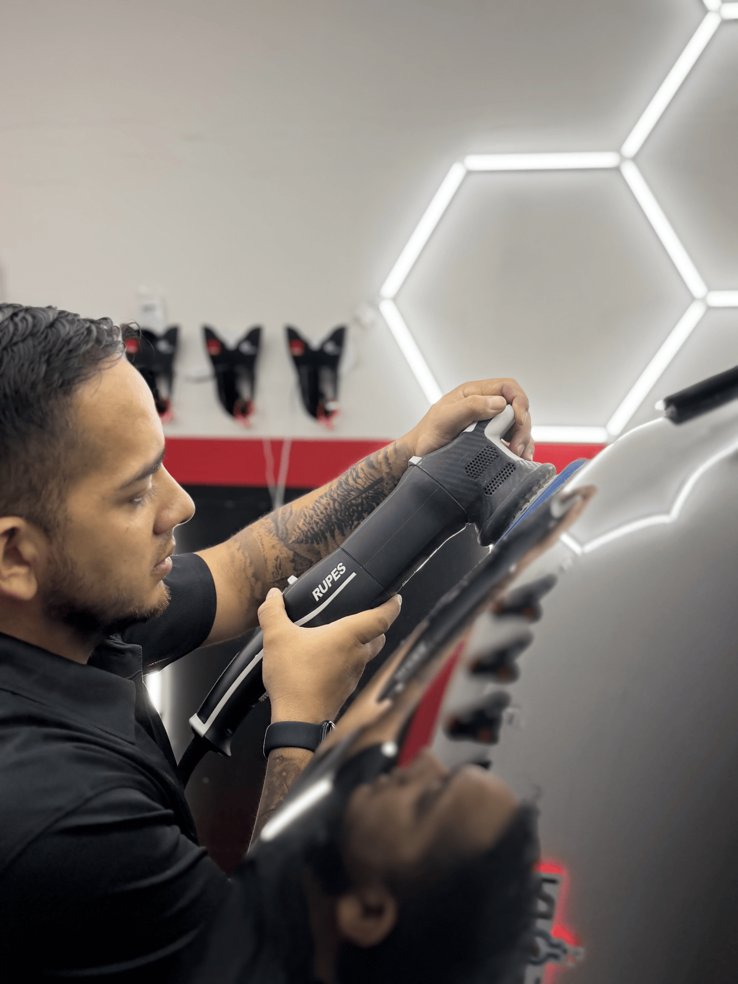 ICON Auto Lab technician machine-polishing a panel with a RUPES polisher before ceramic coating